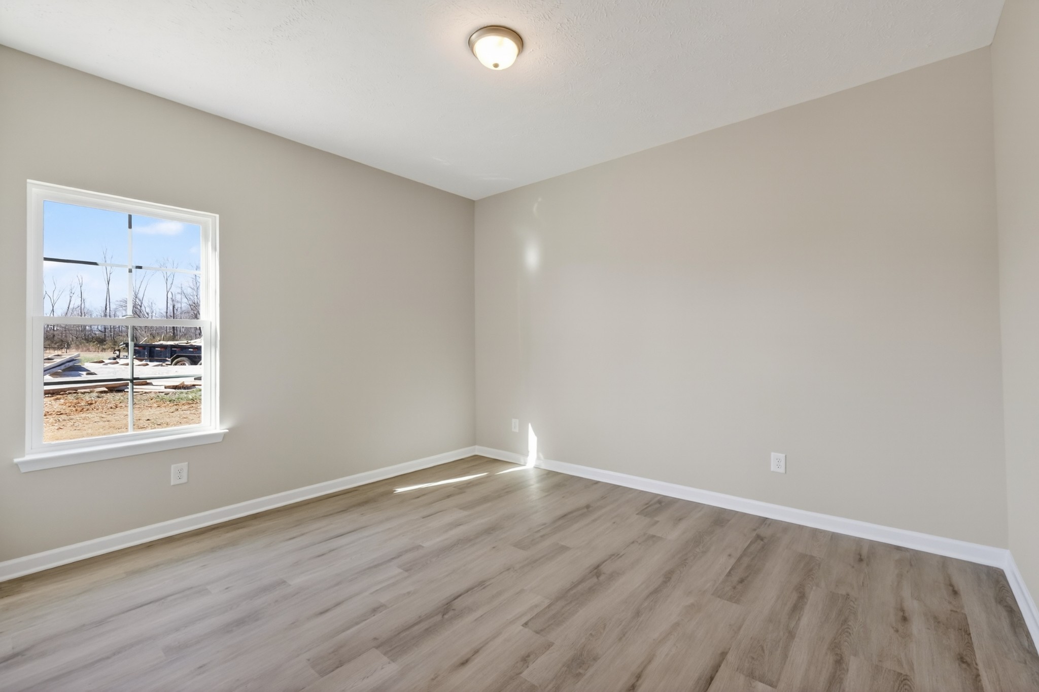 346 North Fork Branch Road Tullahoma, TN 37388 - Photo 7 of 37 a view of an empty room with wooden floor and a window