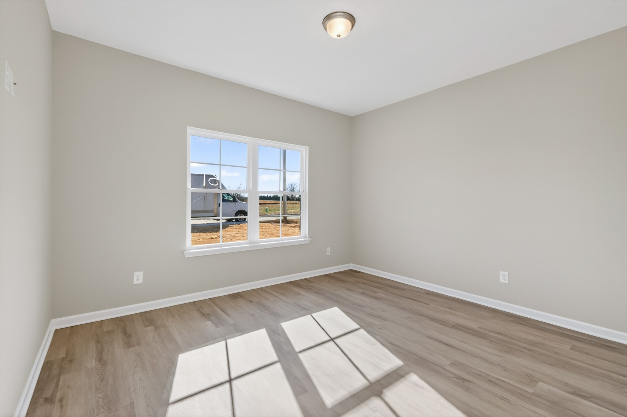 346 North Fork Branch Road Tullahoma, TN 37388 - Photo 9 of 37 an empty room with wooden floor and windows