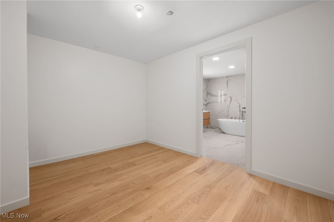 22700 Lake Road, Unit 204 Rocky River, OH 44116 - Photo 14 of 31 Spare room featuring light wood-style floors and recessed lighting
