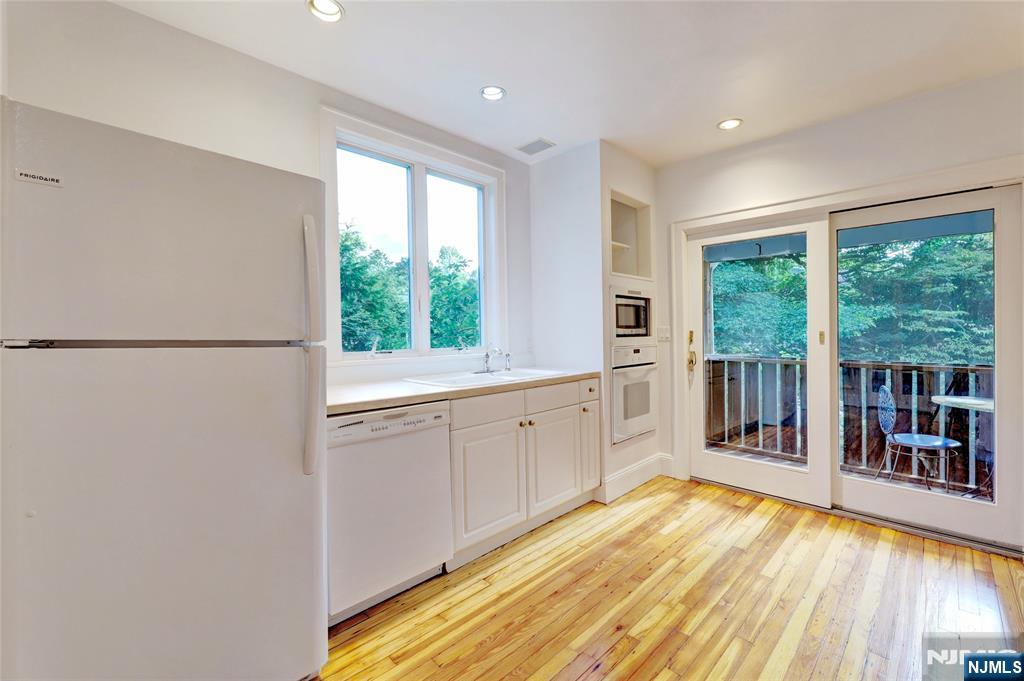 24 Merrifield Way Cresskill, NJ 07626 - Photo 11 of 27 a open kitchen with window and wooden floor