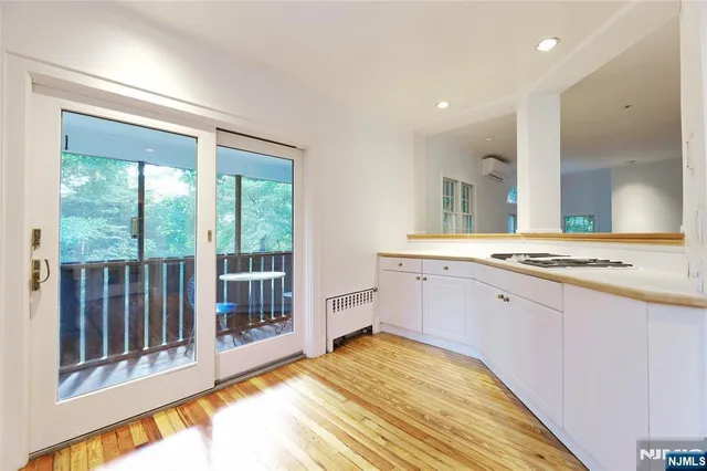 a spacious bathroom with a granite countertop sink and a large mirror
