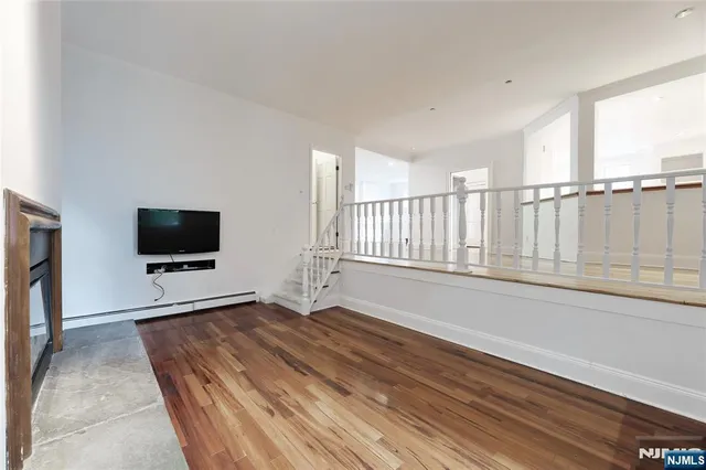 a living room with a flat screen tv and a fireplace