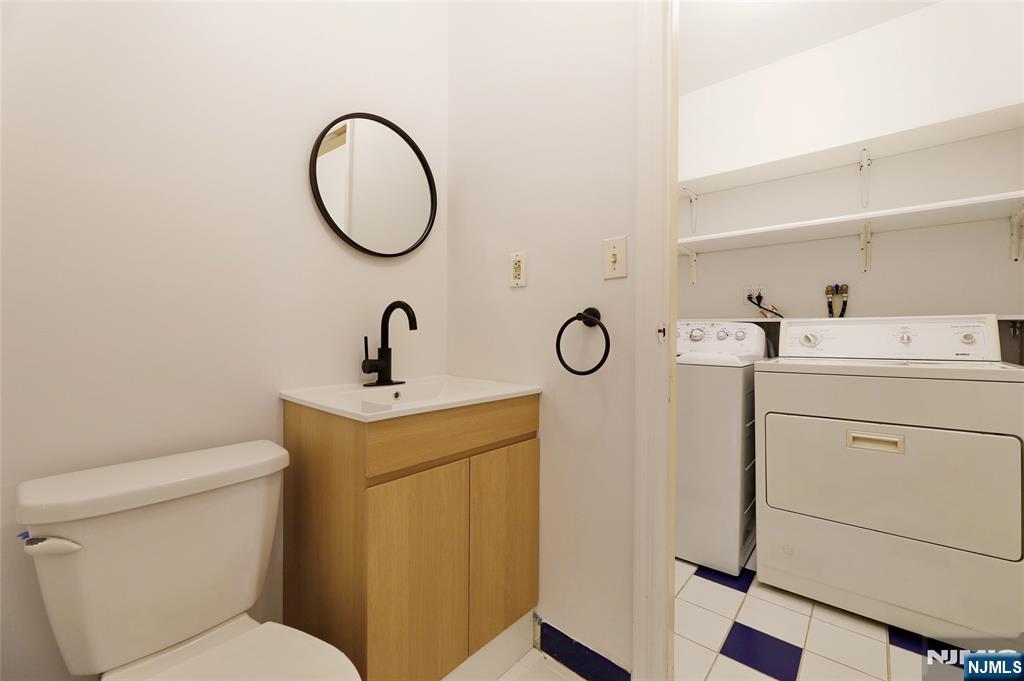 24 Merrifield Way Cresskill, NJ 07626 - Photo 19 of 27 a bathroom with a sink and a mirror