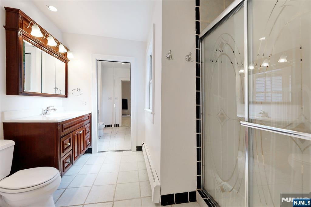 24 Merrifield Way Cresskill, NJ 07626 - Photo 23 of 27 a bathroom with a sink a toilet and shower