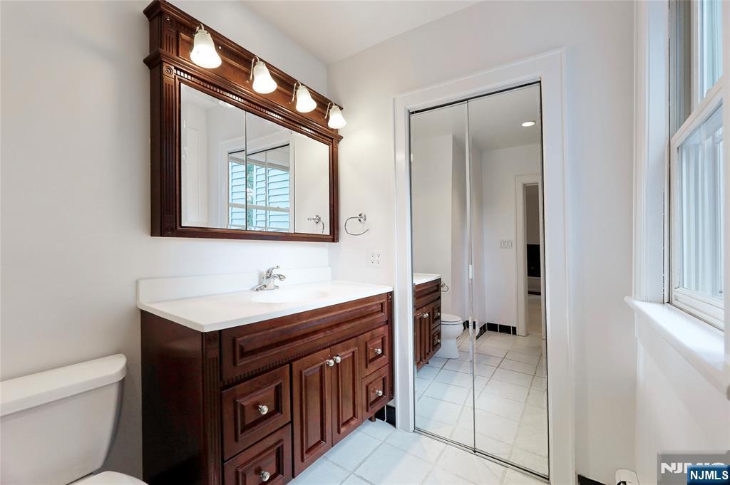 24 Merrifield Way Cresskill, NJ 07626 - Photo 24 of 27 a bathroom with a sink a toilet and a mirror
