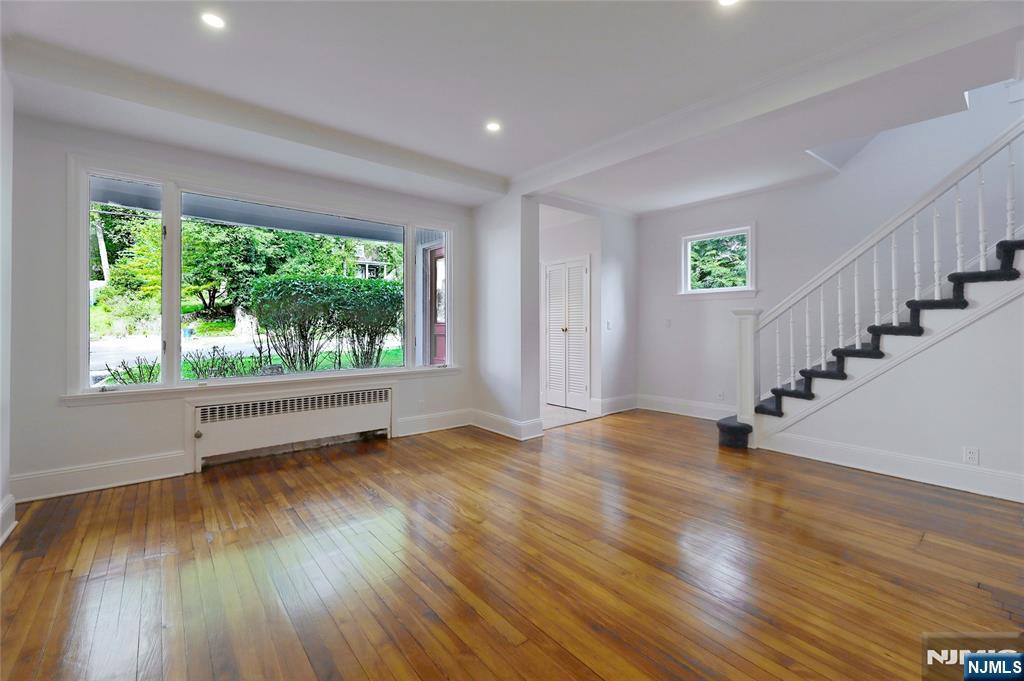 24 Merrifield Way Cresskill, NJ 07626 - Photo 6 of 27 a view of an empty room with wooden floor and a window