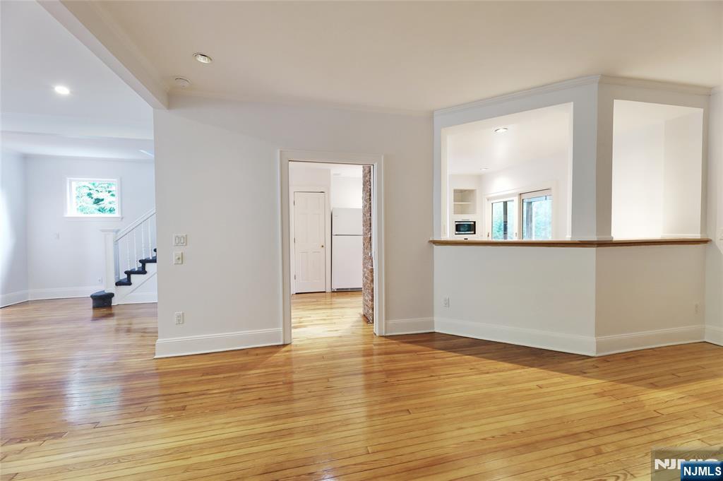 24 Merrifield Way Cresskill, NJ 07626 - Photo 8 of 27 an empty room with wooden floor and windows