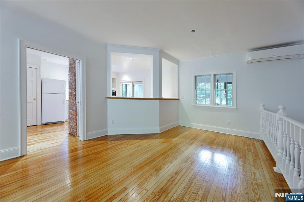 24 Merrifield Way Cresskill, NJ 07626 - Photo 9 of 27 an empty room with wooden floor and windows