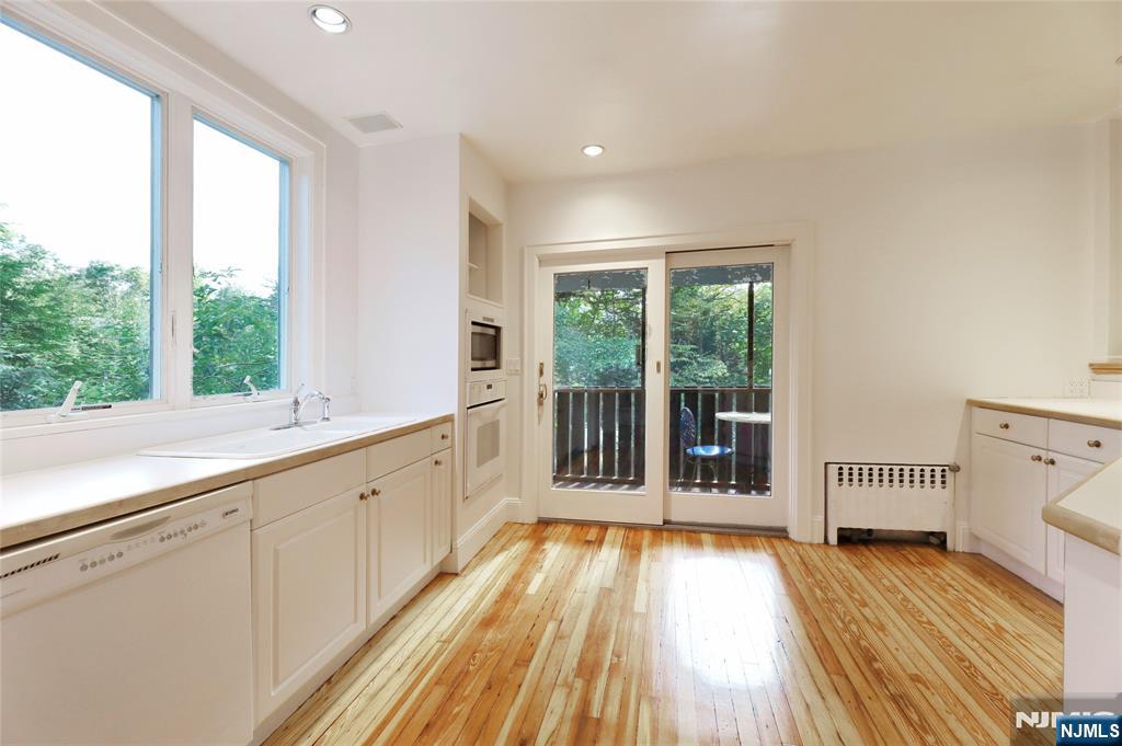 24 Merrifield Way Cresskill, NJ 07626 - Photo 10 of 27 a spacious bathroom with a garden view and wooden floor