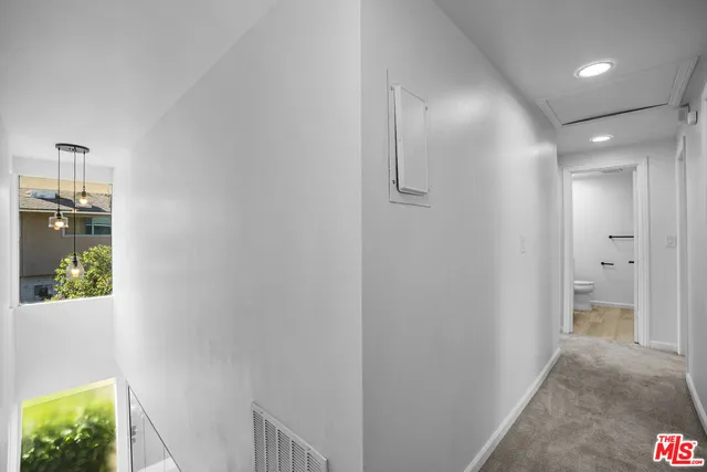 a view of hallway with livingroom and hardwood
