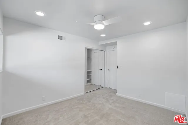 en empty room with windows and closet