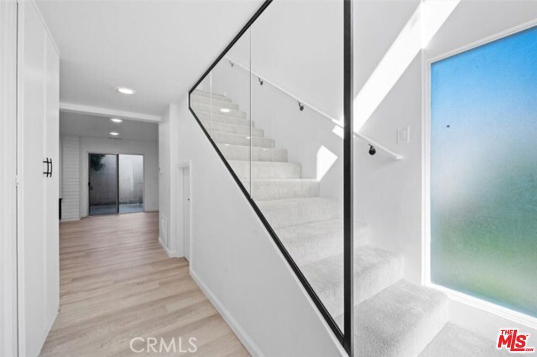 963 Glencliff Street La Habra, CA 90631 - Photo 3 of 31 a view of a hallway with wooden floor and staircase