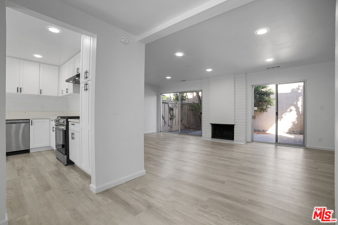 963 Glencliff Street La Habra, CA 90631 - Photo 6 of 31 a view of an empty room with wooden floor and a kitchen
