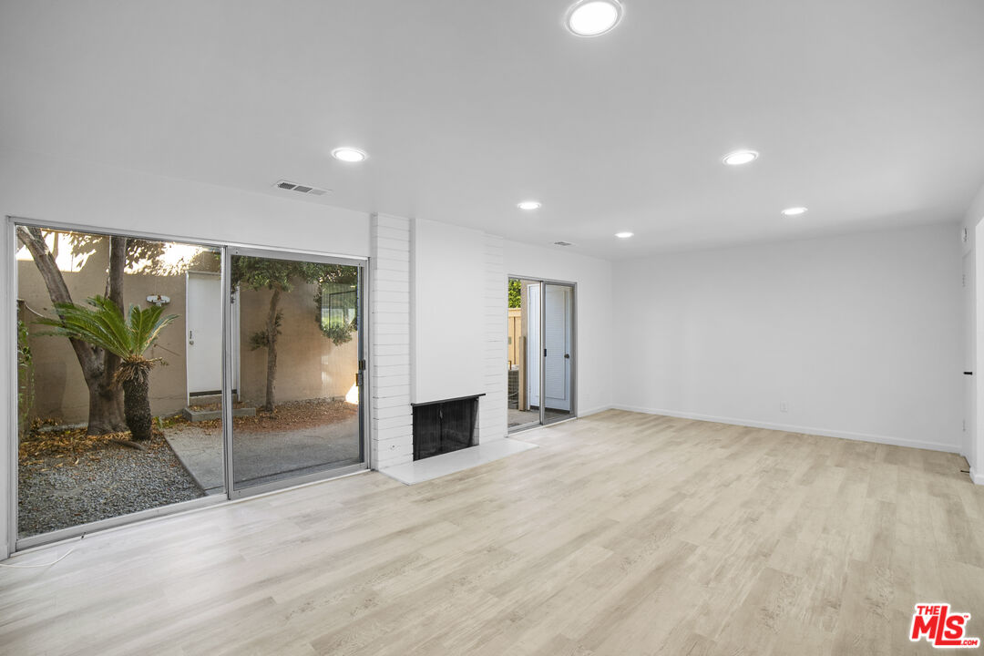 963 Glencliff Street La Habra, CA 90631 - Photo 8 of 31 a view of an empty room with glass door and windows