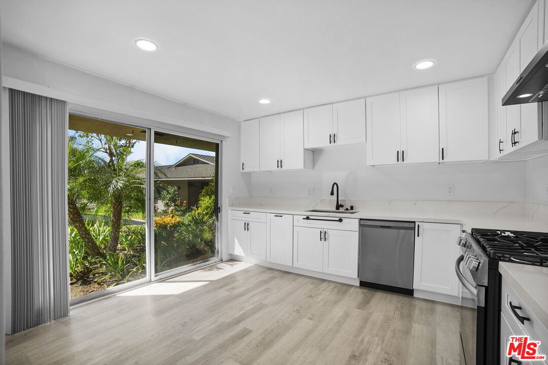 963 Glencliff Street La Habra, CA 90631 - Photo 10 of 31 a kitchen with appliances cabinets and a wooden floor