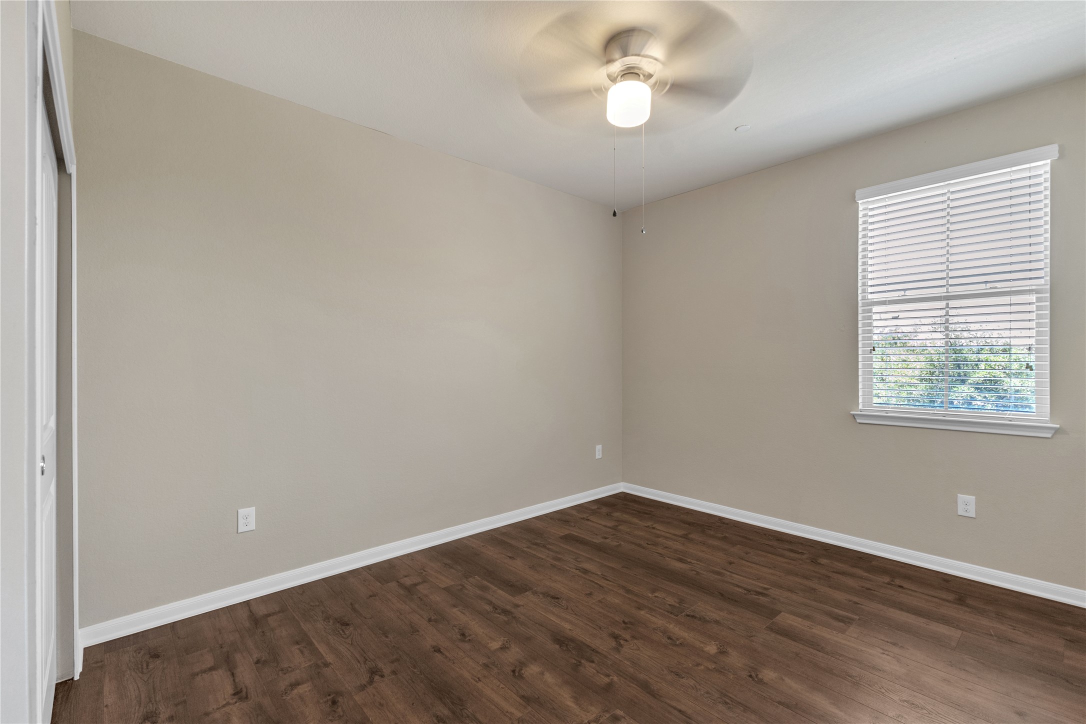 2880 Donnell Drive, Unit 2003 Round Rock, TX 78664 - Photo 24 of 31 Neutral-toned interior room featuring wood-finish flooring, a ceiling fan with integrated lighting, and a window with blinds