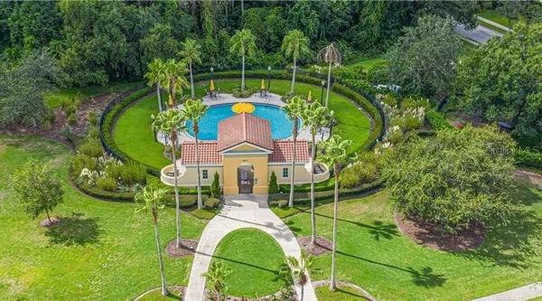an aerial view of a house with a big yard and large trees