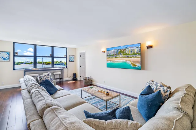 a living room with furniture and a floor to ceiling window