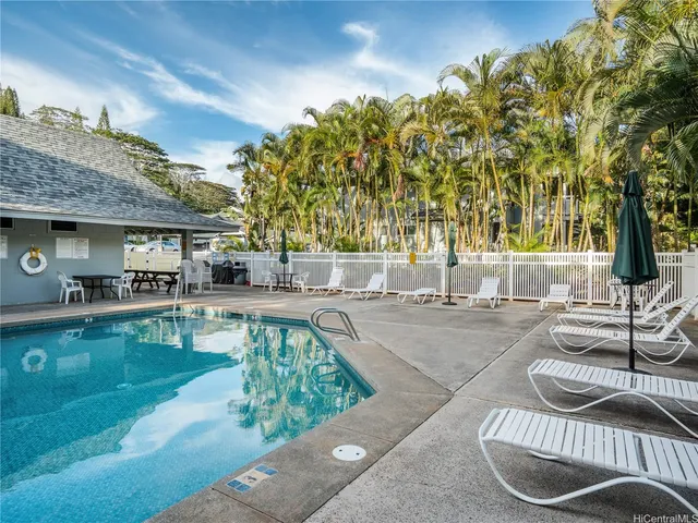 a swimming pool with outdoor seating and yard