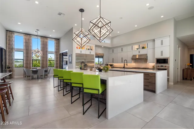 a kitchen with sink cabinets and dining table chair
