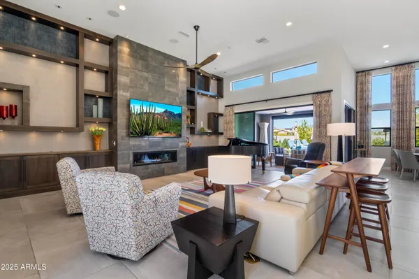 a living room with fireplace furniture and a flat screen tv