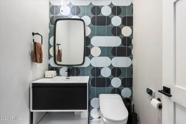 a spacious bathroom with double vanity and a mirror