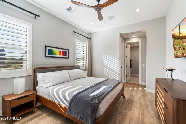 a bathroom with a granite countertop sink a toilet and a mirror