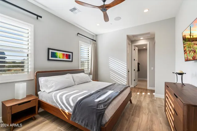 a bathroom with a granite countertop sink a toilet and a mirror