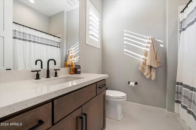 a bathroom with a double vanity sink mirror and shower
