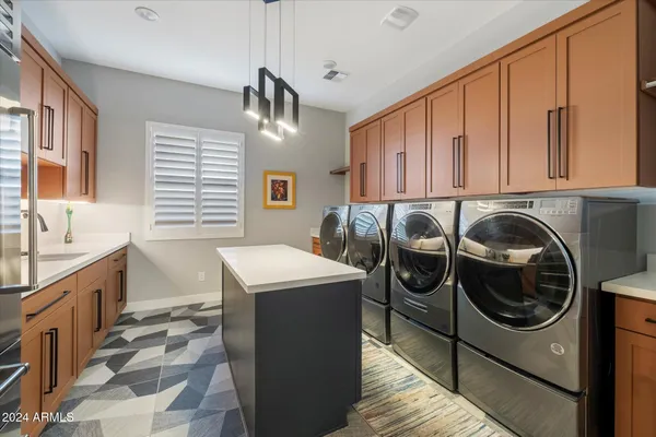 a view of a dining room and livingroom with furniture wooden floor and a rug