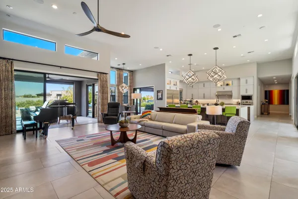 a living room with lots of furniture and kitchen view