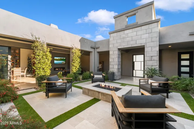 a view of a house with a patio and garden