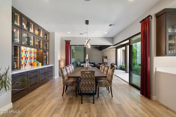 a dining room with furniture a flat screen tv and wooden floor