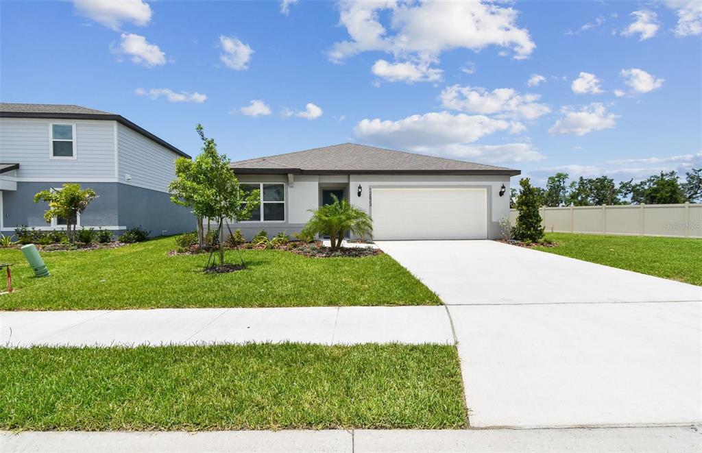 12823 Wanderlust Place Parrish, FL 34219 - Photo 1 of 1 a front view of a house with a yard