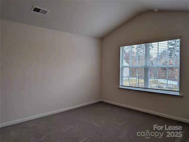 a view of a room that has a window and a door