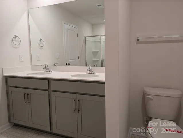 a bathroom with a glass shower door