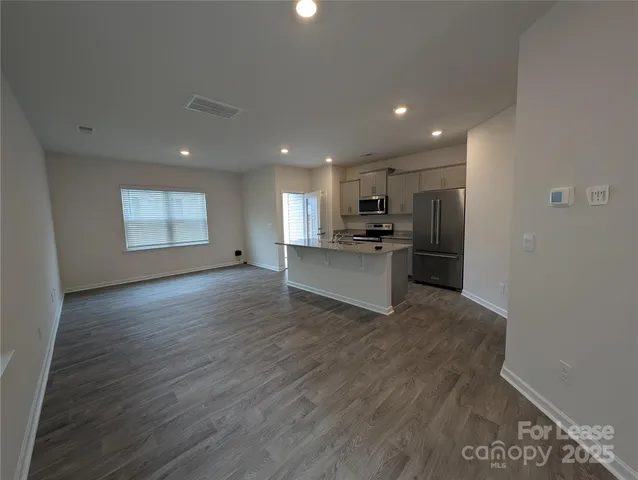 a view of a kitchen with a sink and a refrigerator