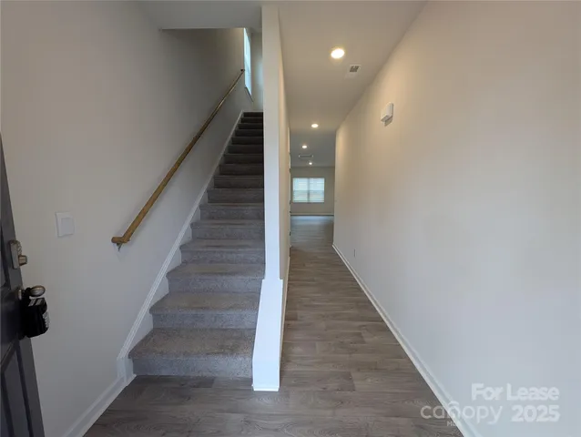 a view of entryway and hall with wooden floor