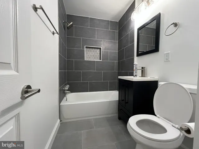 a bathroom with a toilet a sink and bathtub