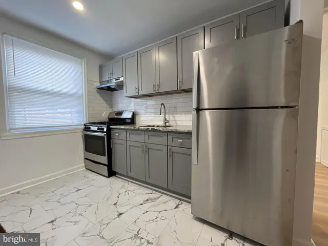 a kitchen with stainless steel appliances granite countertop a refrigerator sink and cabinets