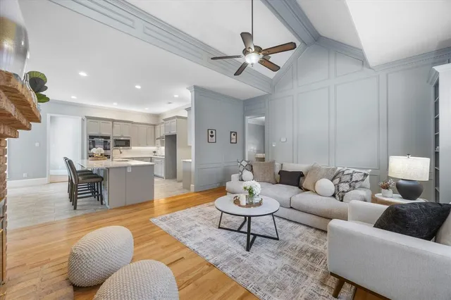 a living room with furniture kitchen view and a table
