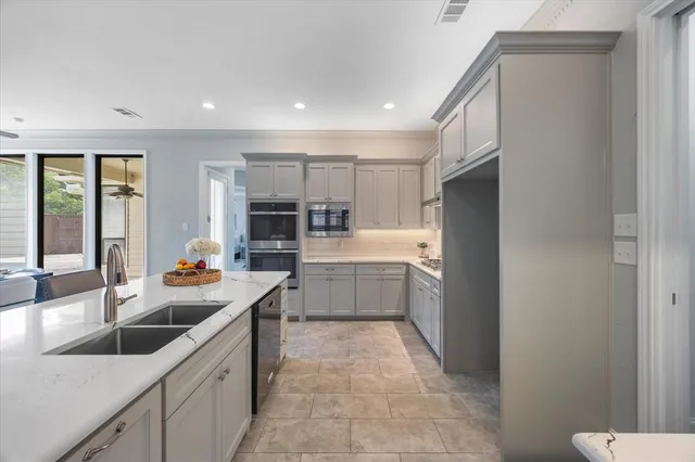 a kitchen with stainless steel appliances a sink stove and cabinets