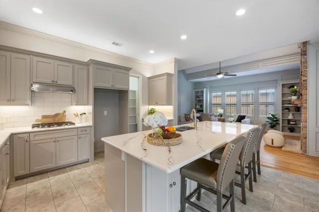 a kitchen with granite countertop kitchen island white cabinets and stainless steel appliances