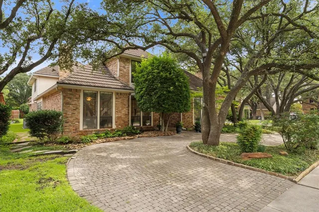 front view of a house with a tree in front of it