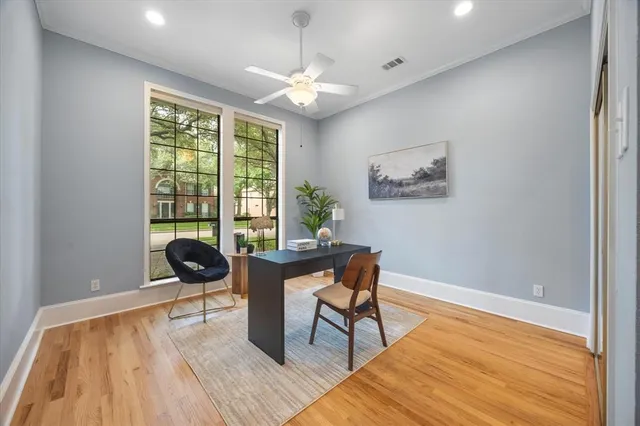 a view of a workspace with furniture and a window