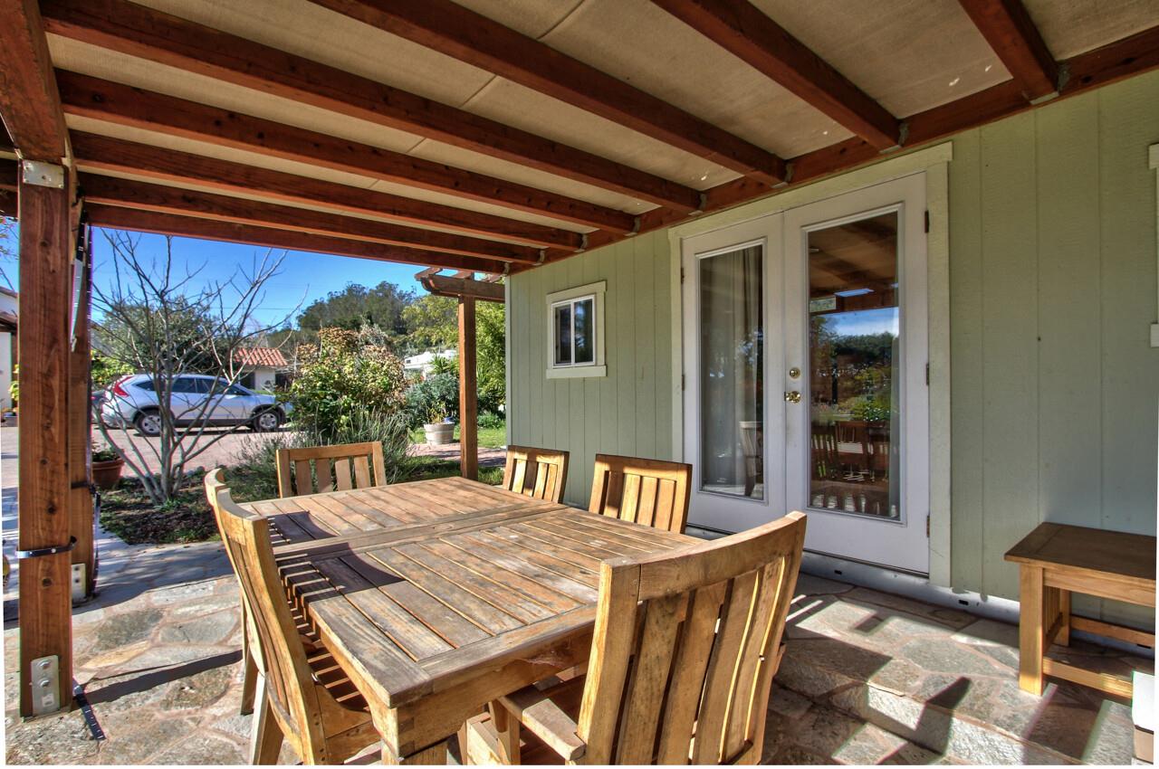 545 Pini Road Watsonville, CA 95076 - Photo 11 of 18 a view of a patio with a table chairs and a backyard