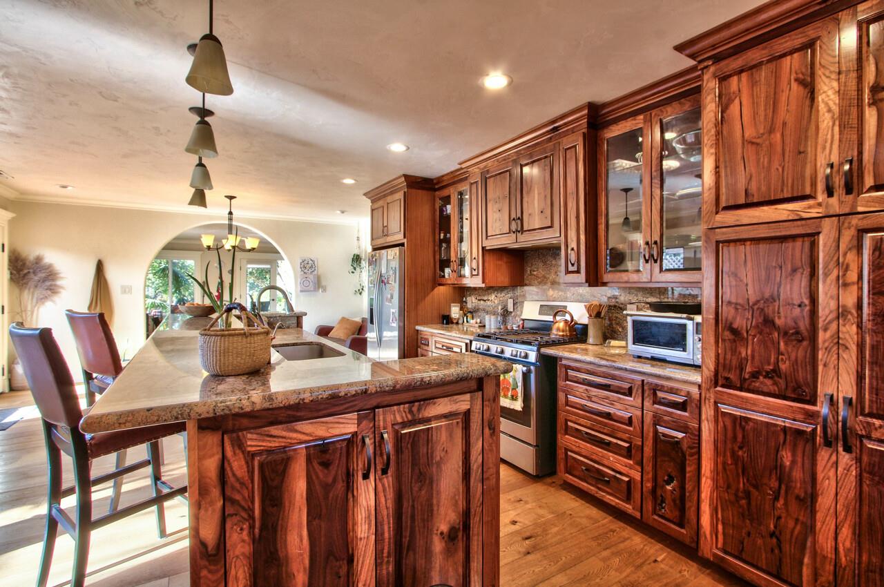 545 Pini Road Watsonville, CA 95076 - Photo 4 of 18 a kitchen with stainless steel appliances granite countertop a stove top oven a refrigerator a sink and dishwasher with wooden floor