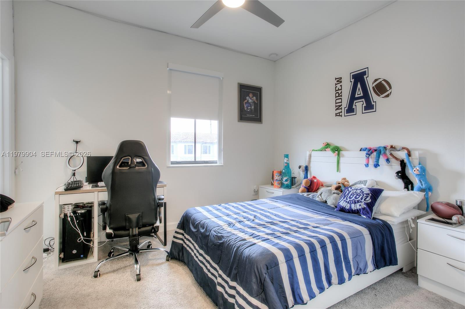 11849 Southwest 247th Terrace Homestead, FL 33032 - Photo 11 of 13 a bedroom with a bed gym equipment and a chandelier