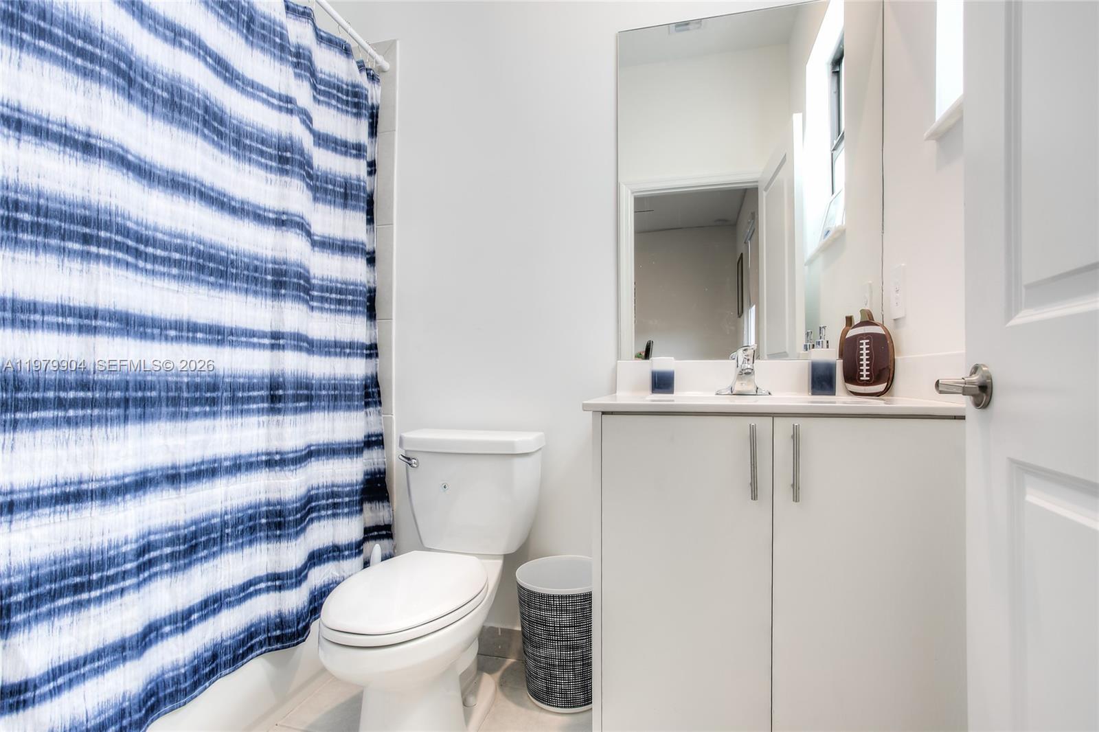11849 Southwest 247th Terrace Homestead, FL 33032 - Photo 12 of 13 a bathroom with a sink toilet and mirror