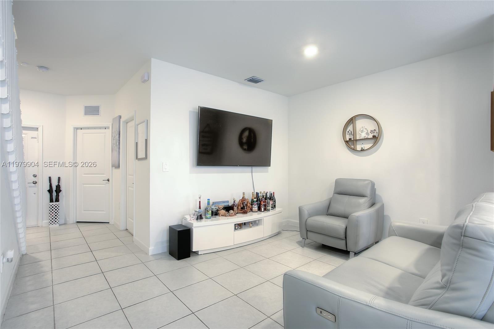 11849 Southwest 247th Terrace Homestead, FL 33032 - Photo 5 of 13 a living room with furniture and a flat screen tv